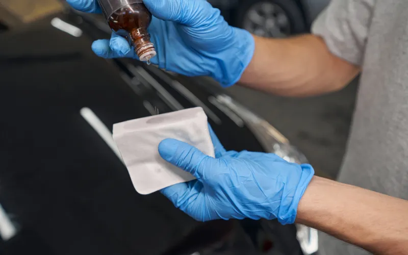 detailer applying ceramic product to applicator