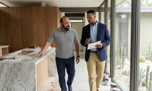 project manager reviewing remodel blueprints