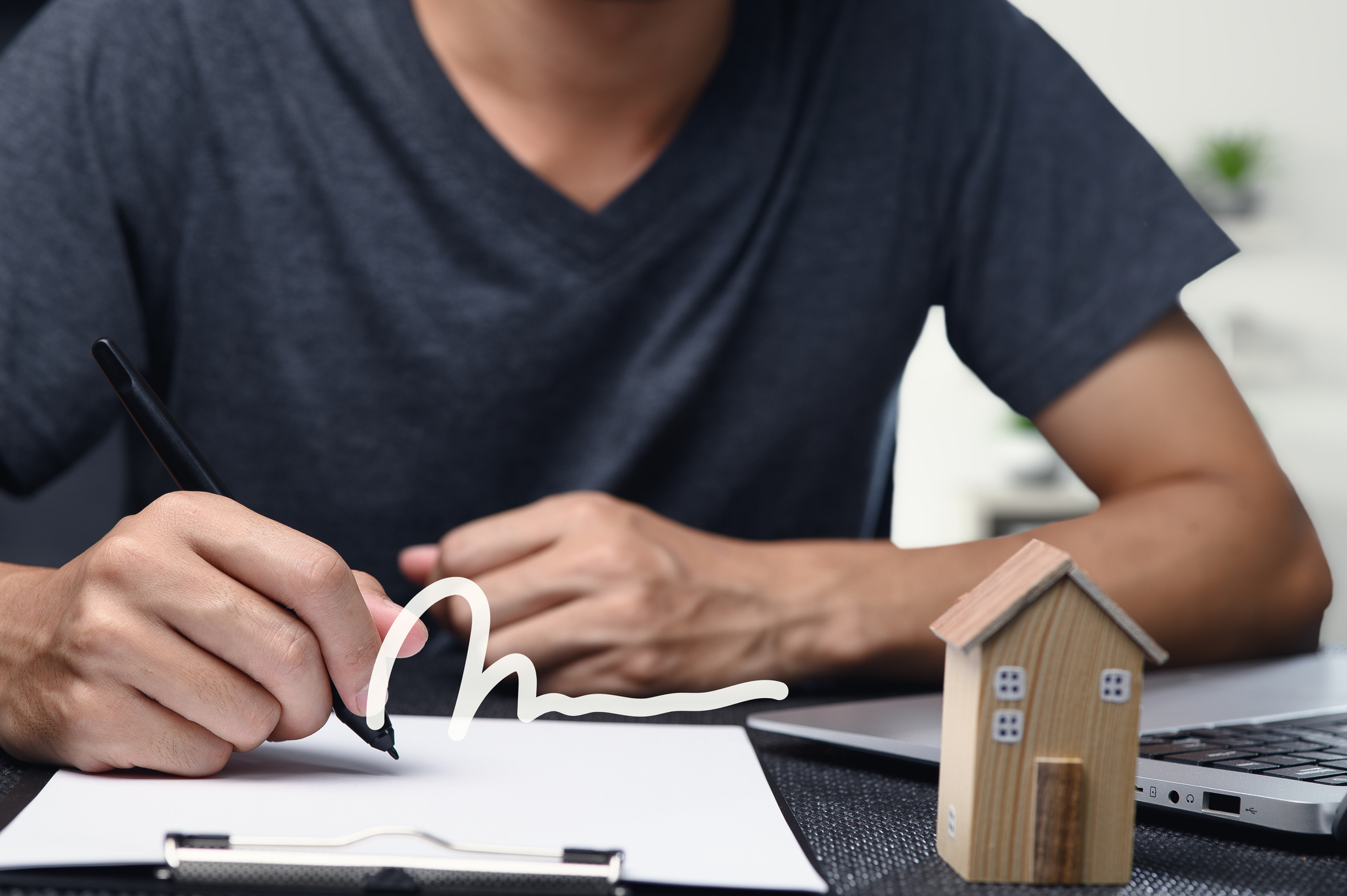 Homeowner shaking hands with Atlanta cash home buyer at closing table after selling house fast.