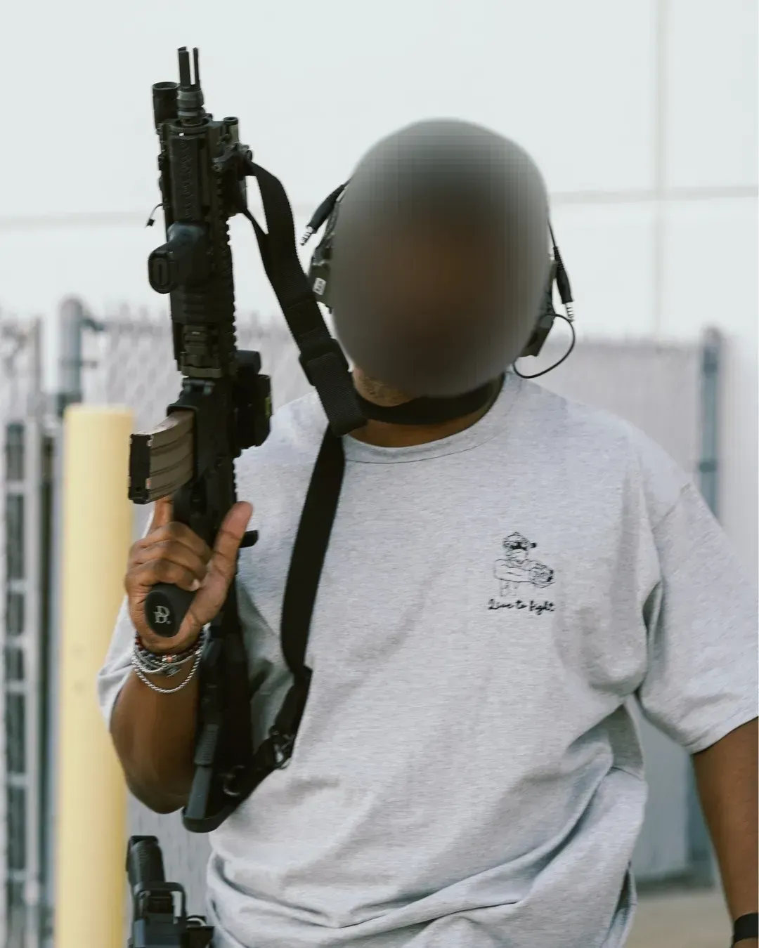 man carrying a rifle pointed towards the sky is walking