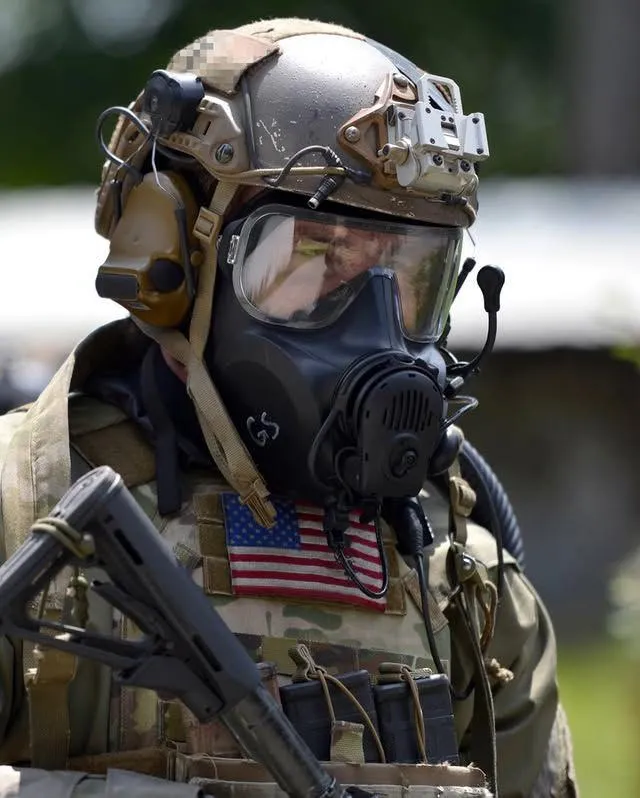 soldier in full combat gear and a gas mask