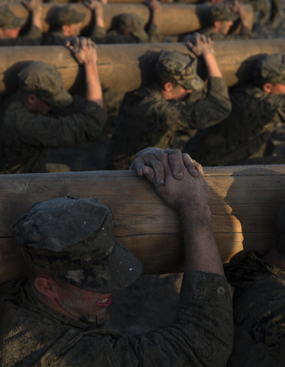 soldiers doing pt and carrying logs