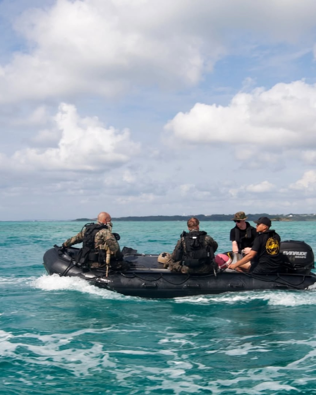 Sailors across navy ranks operating a rigid-hull inflatable boat during a maritime insertion