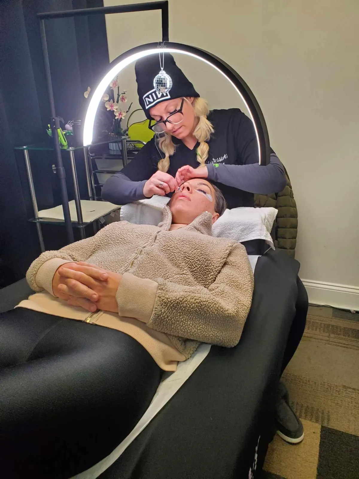 Lash artist applies lash extensions to a client at Lash Expressions Salon