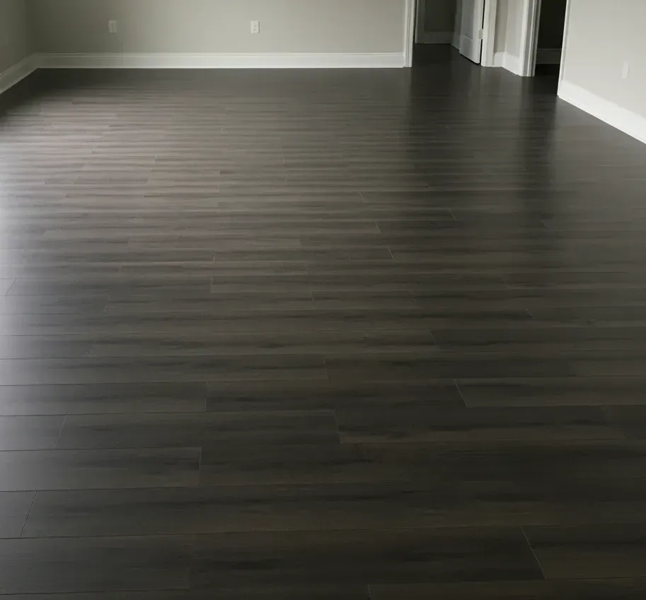 Vinyl sheet flooring installation with dark grey wood-look finish – All Type Floors