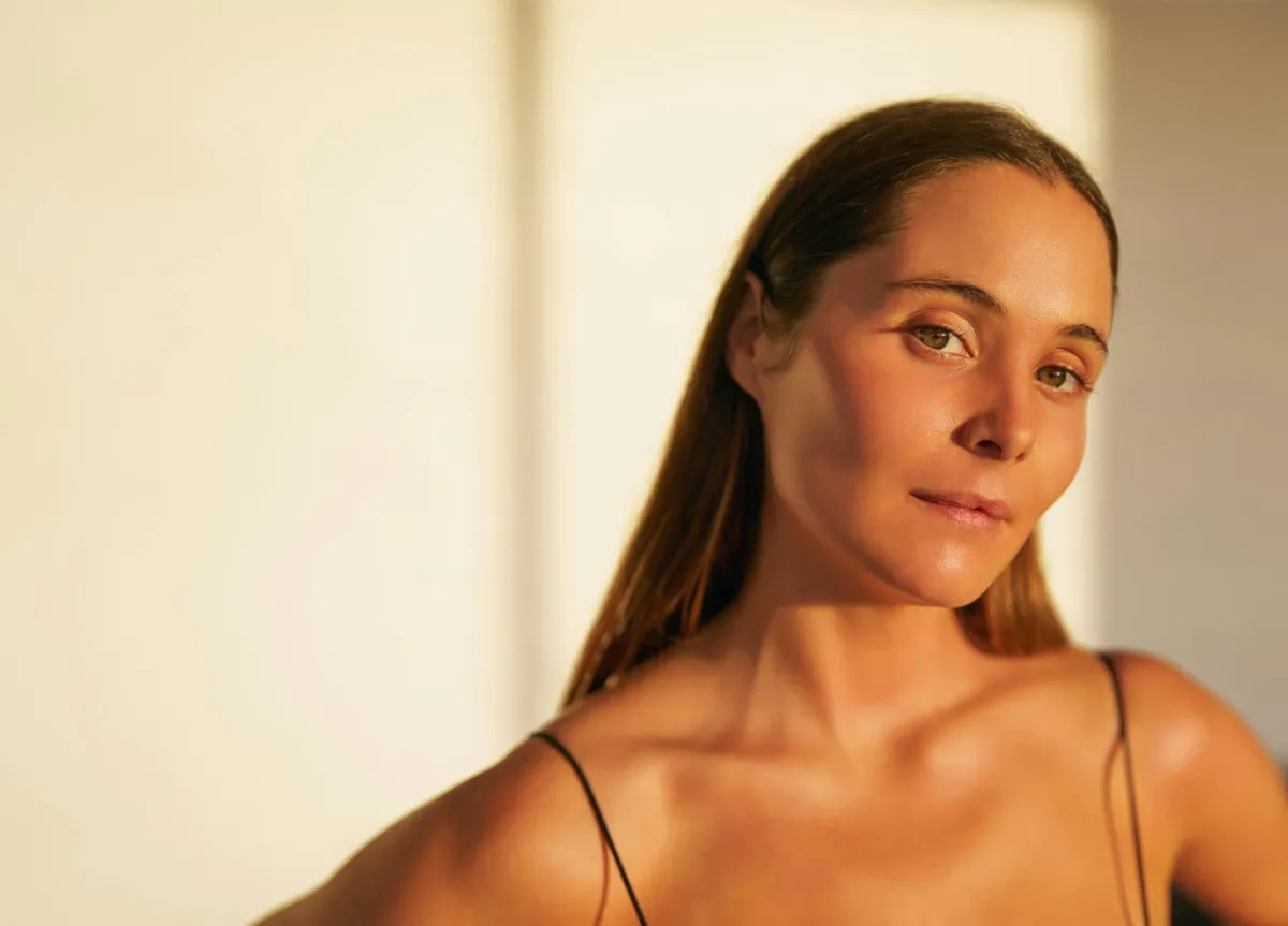 person in white dress shirt wearing green and white hat