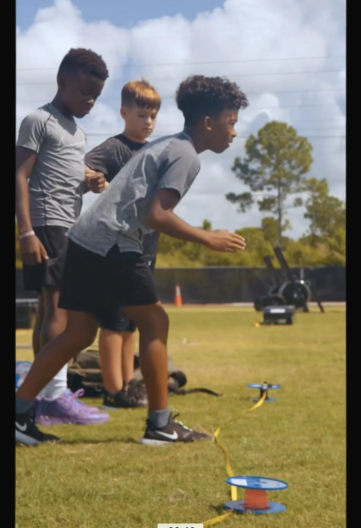 Young athletes at PROTRAIN speed camp practicing sprint drills to improve acceleration and agility. Elite summer training for youth athletes aiming for peak performance in sports.