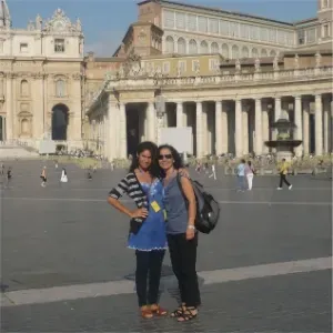 Two women posing in front of St. Peter's Basilica in Vatican City