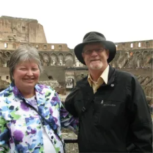 Smiling couple posing inside the Colosseum in Rome, Italy