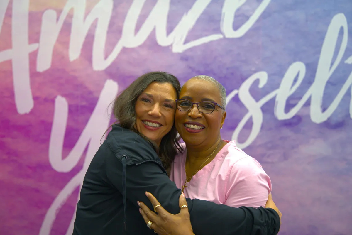 Curves coach hugging gym member