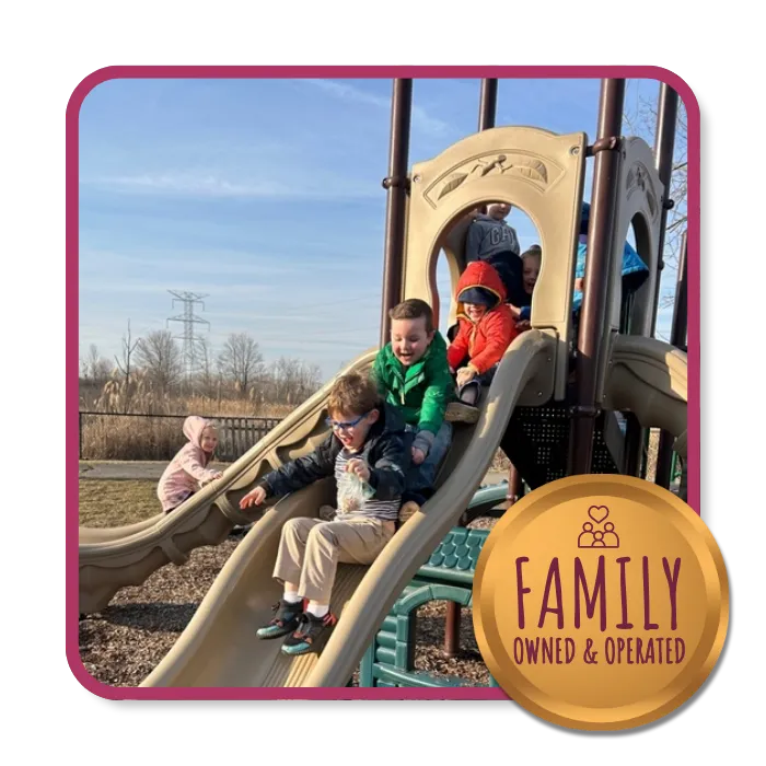 Children playing on a slide at Rosebrook Child Development Center in Wixom, Michigan, learning through play.