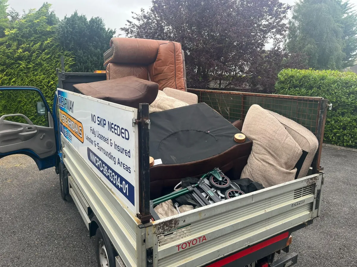Old sofa being loaded for removal