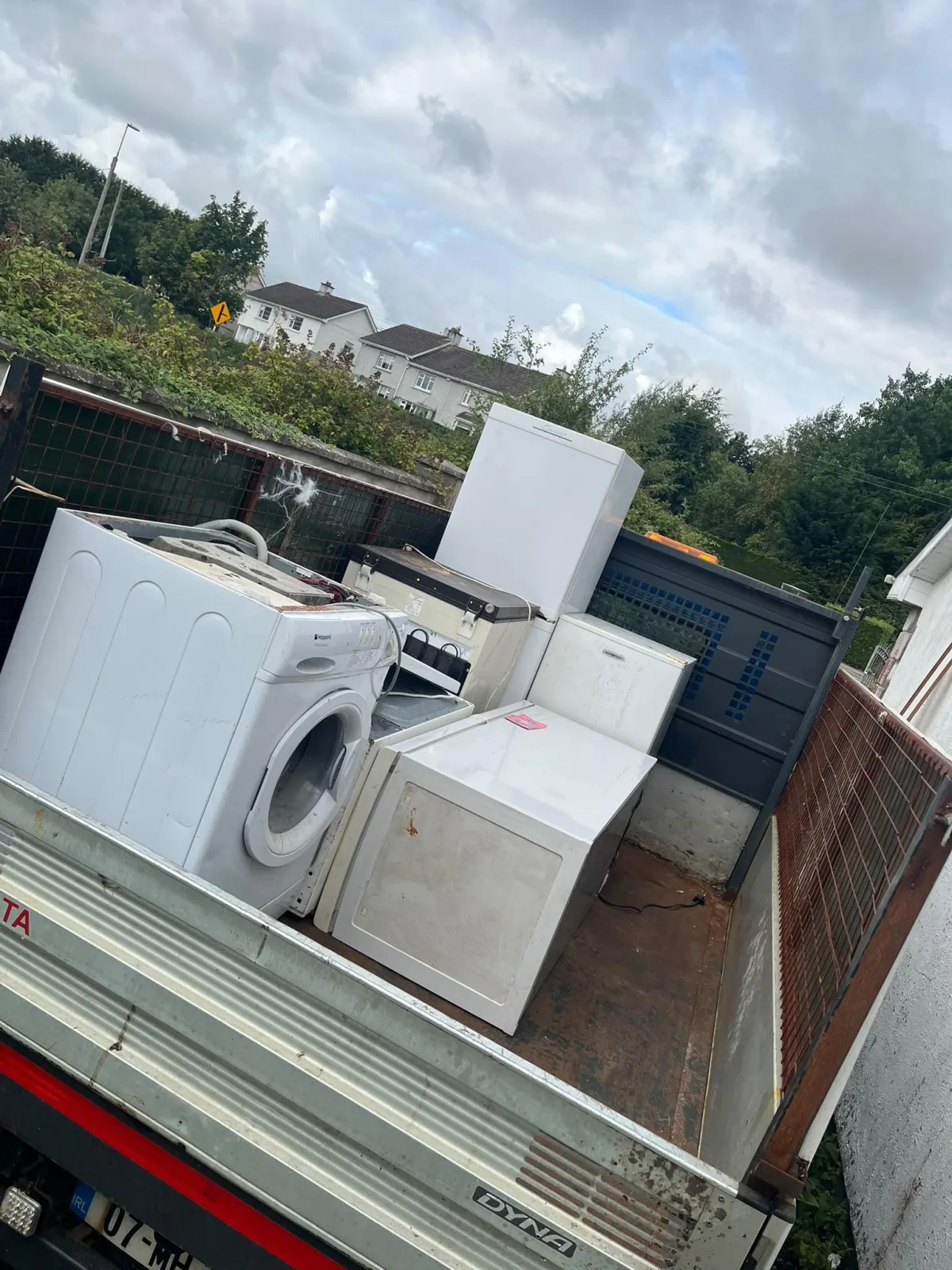 Old sofa being loaded for removal