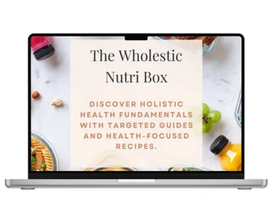 Laptop displaying “The Wholestic Nutri Box” over a plate of colorful whole foods including vegetables, fruits, and grains.