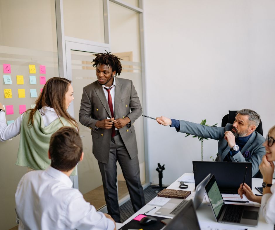 Busy professionals in a workplace meeting, reflecting high-stress environments and modern work-life challenges