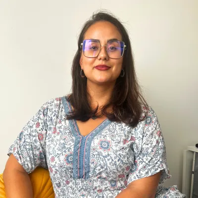 Professional woman sitting calmly, representing everyday balance and realistic wellness for busy lifestyles