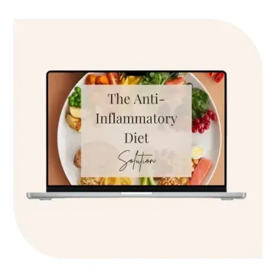 Laptop displaying “The Anti-Inflammatory Diet Solution” over a plate of colorful whole foods including vegetables, fruits, and grains.