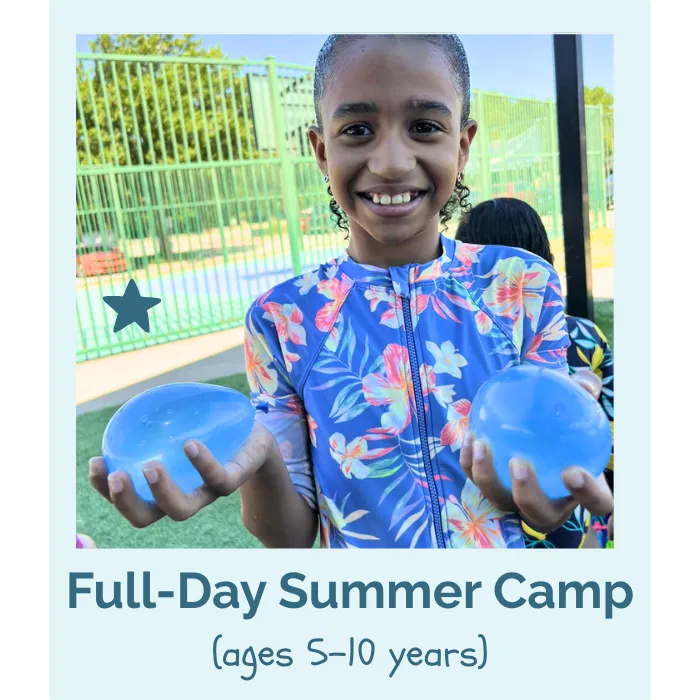 child playing in splash pad at summer camp