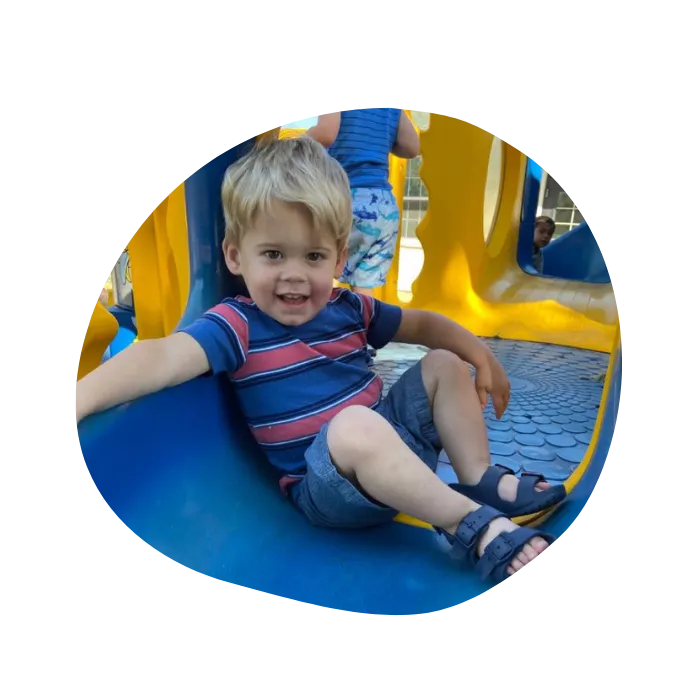 child playing outside in playground facilies