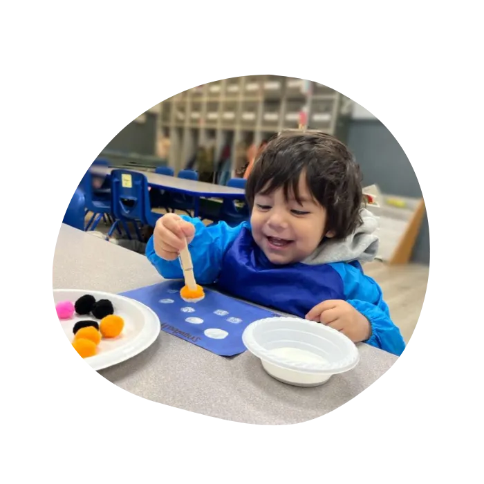 happy child doing arts and crafts in childcare facility
