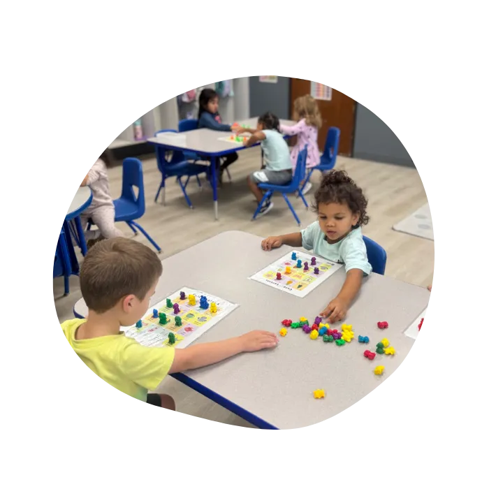 toddlers playing with educational toys in daycare classroom