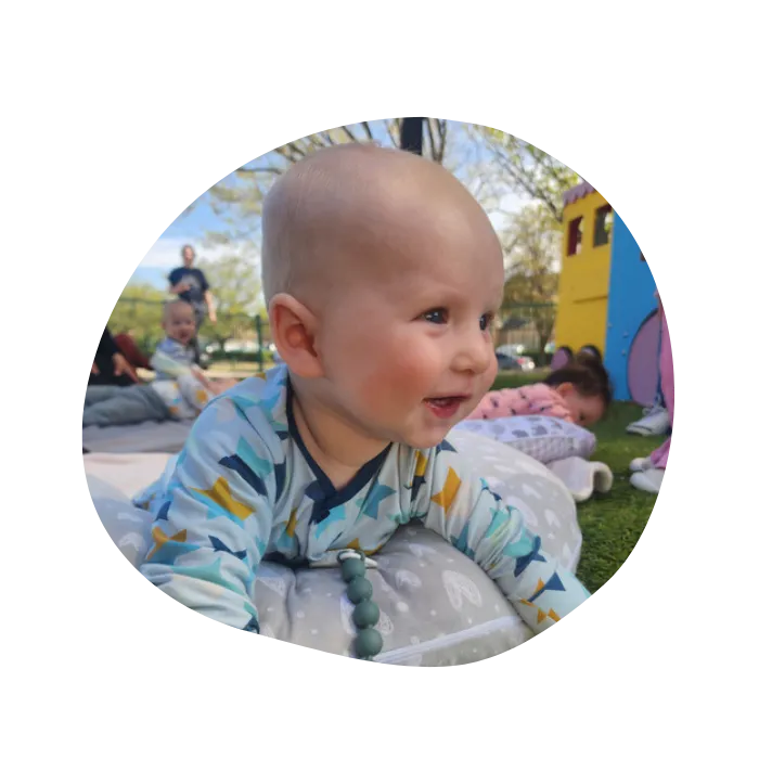 happy infant playing outide at daycare