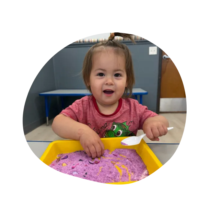 toddlers playing with sensory toys in a safe childcare environment