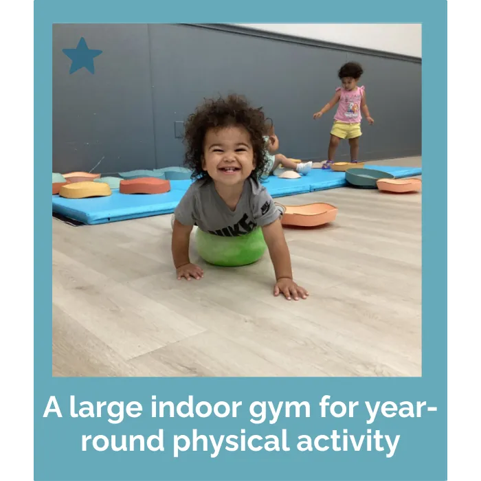 child playing in indoor gym at childcare facility