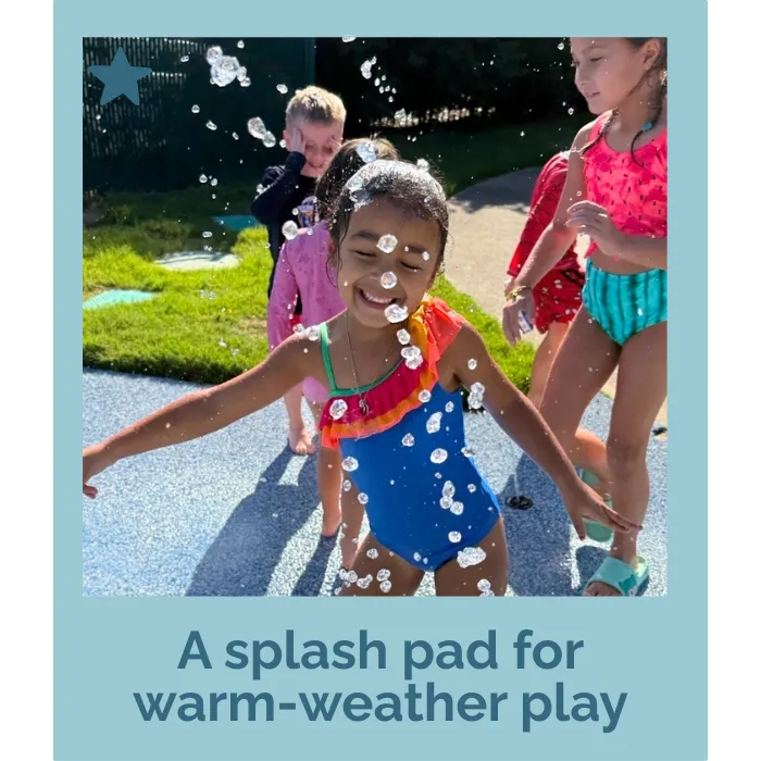 child playing outside on splash pad
