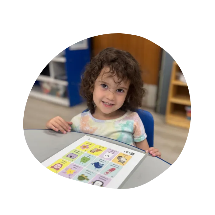 child learning how to read and write in preschool