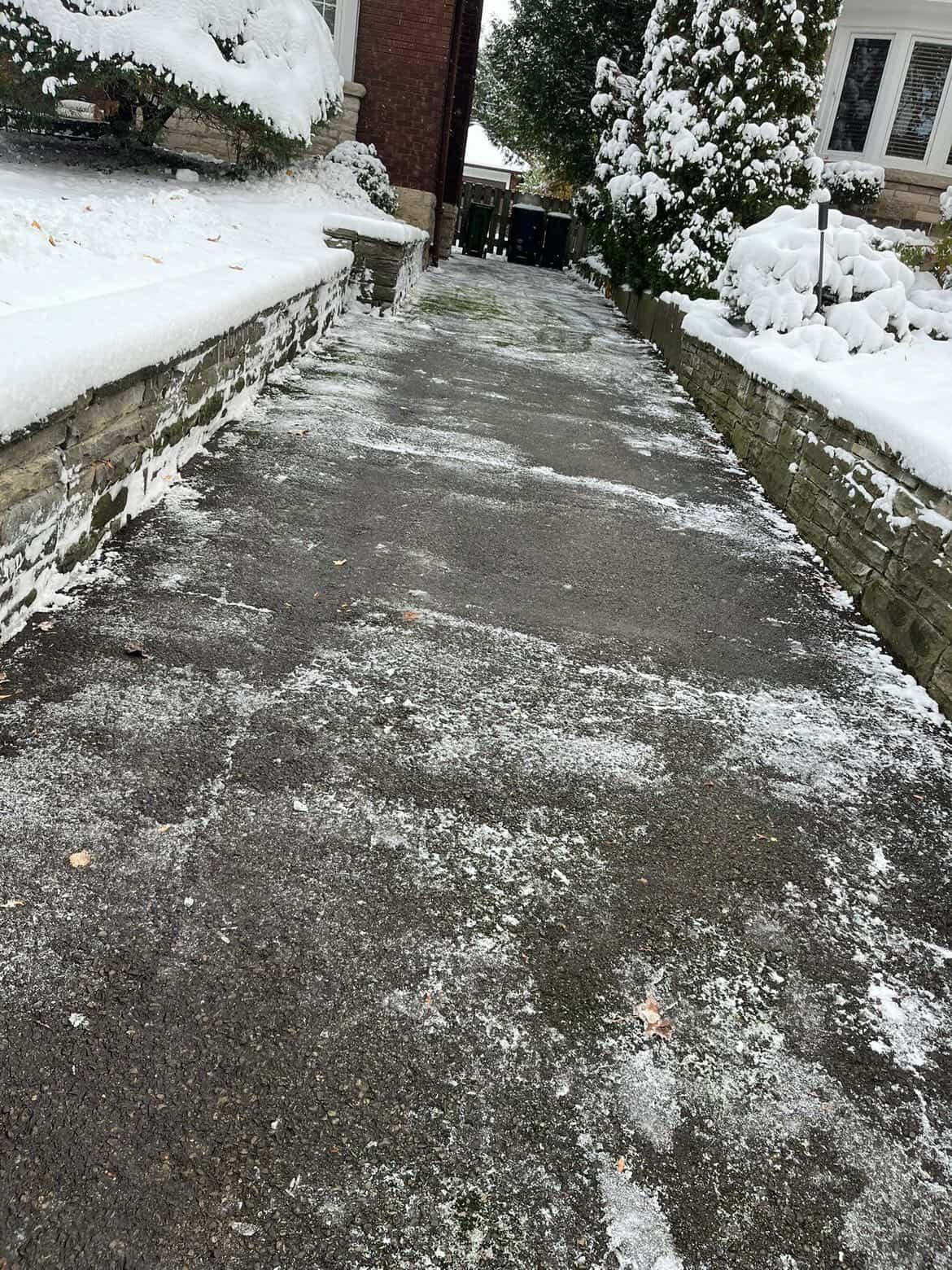 Snow removal professional spreading salt on an icy driveway
