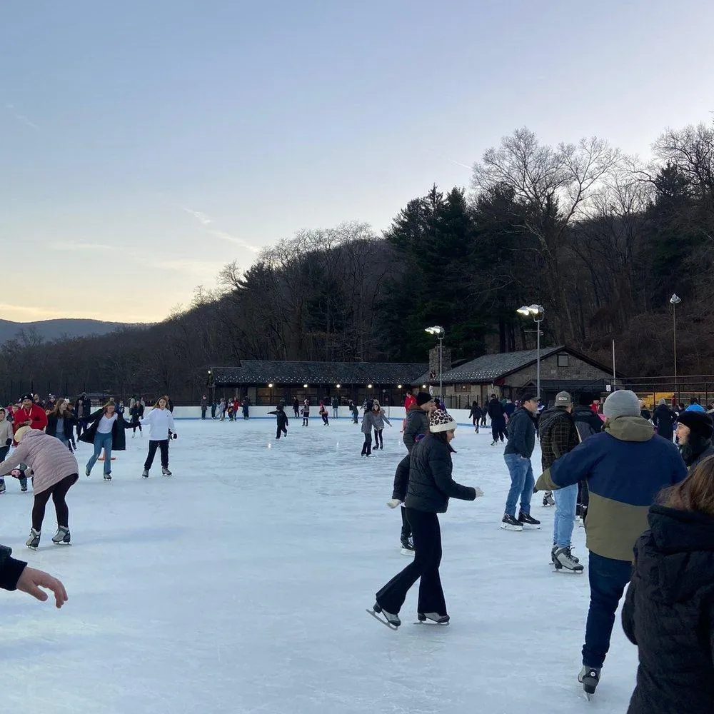 Snow-covered park in Morris County NJ with families enjoying winter activities and holiday charm.