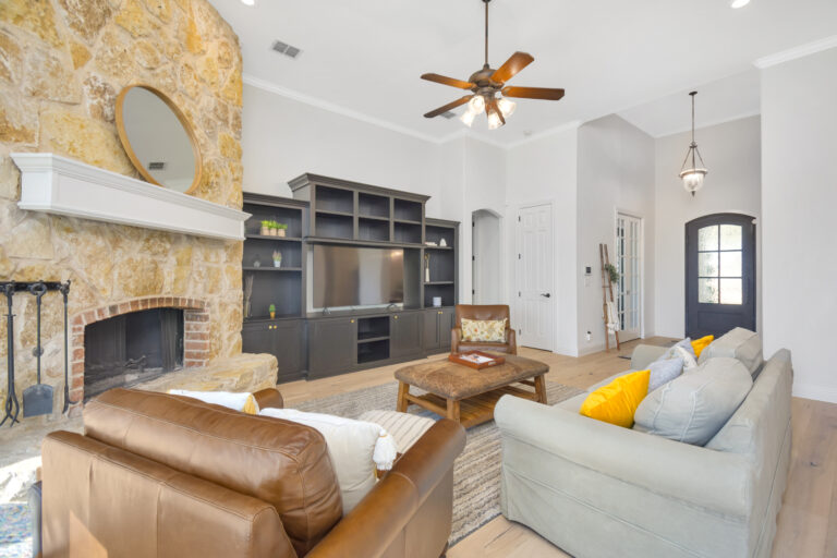 Close-up of a dripping kitchen faucet with a worried homeowner in the background, holiday decorations visible. The image highlights the urgency of plumbing issues during festive times. 3:2 aspect ratio.