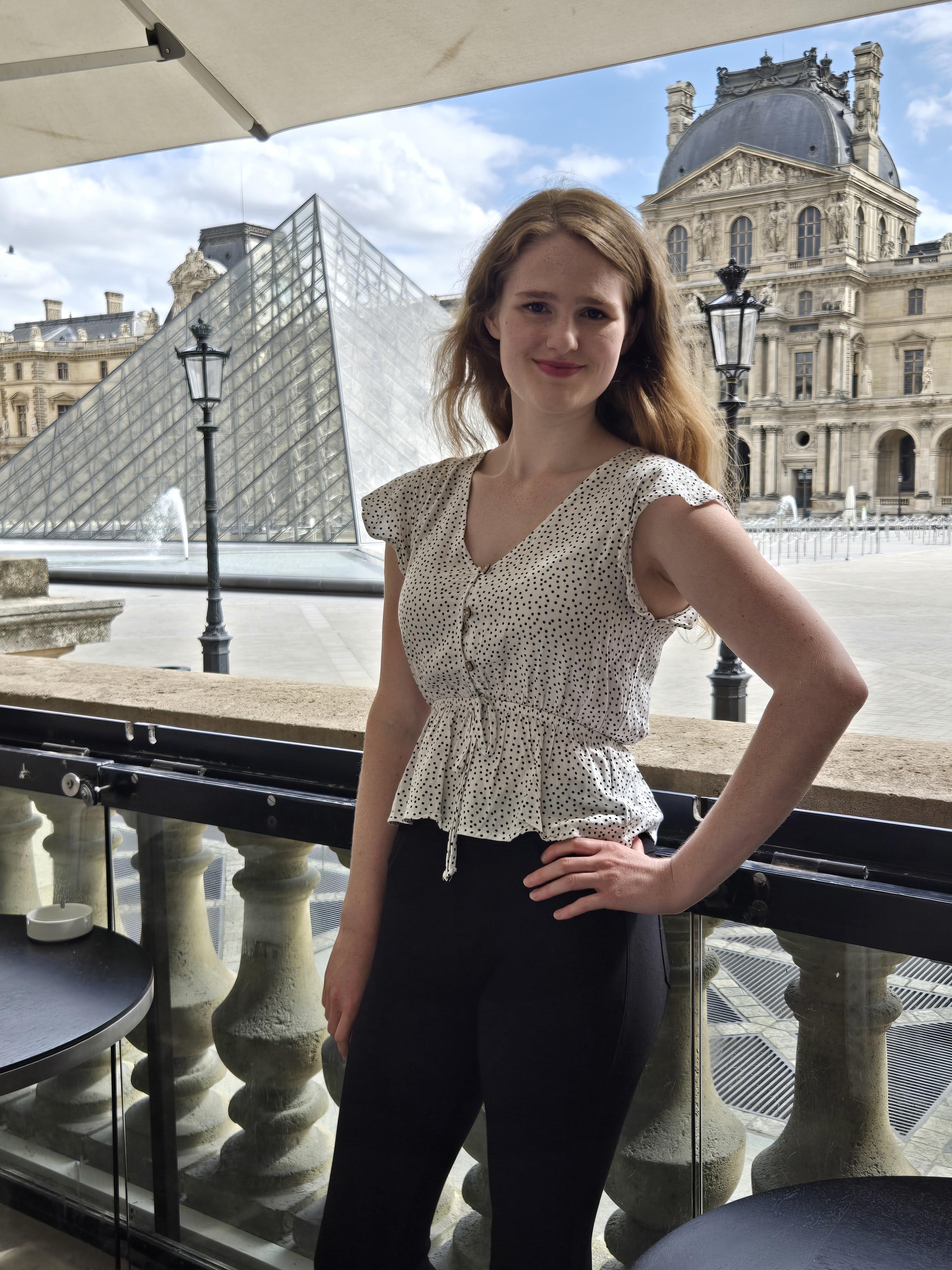 SharmaLia Jones, founder and interior designer at SharmaLia Jones Designs, pictured in Paris at the Louvre Pyramids 