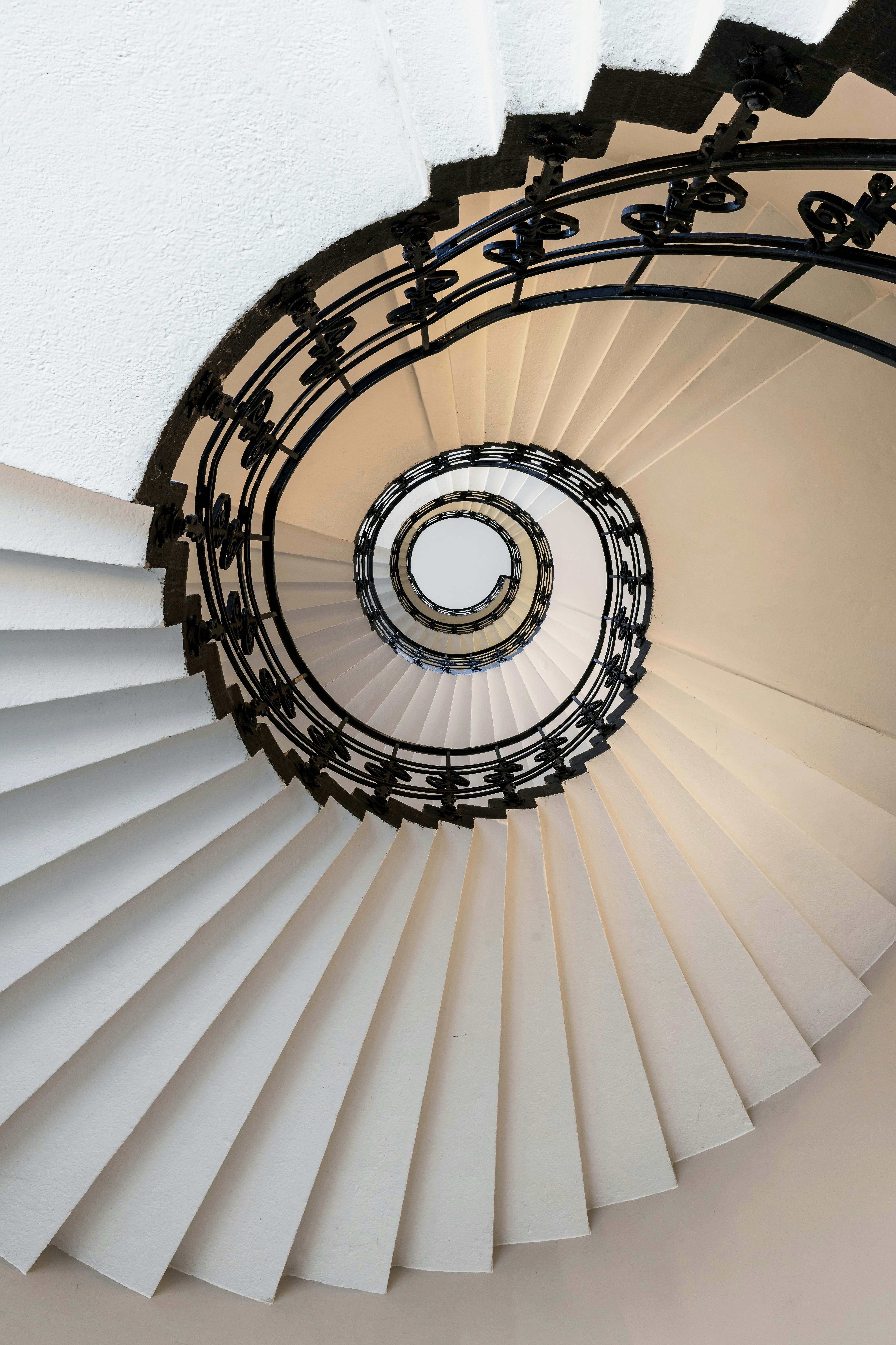 Ornate spiral staircase with wrought-iron railing virtual interior design service