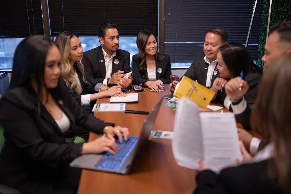 Team collaborating around a conference table on protection planning
