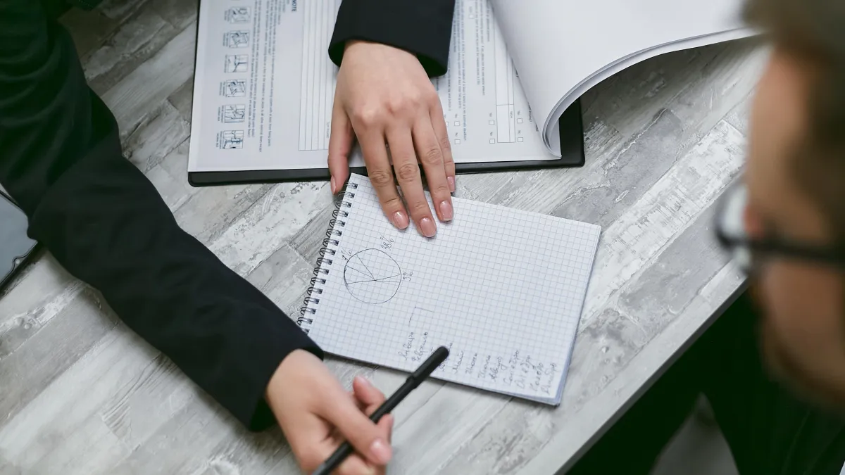 person writing on white paper