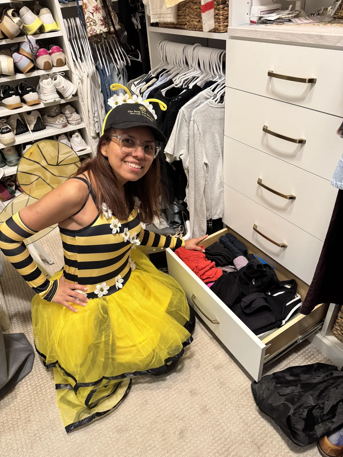 Perfectly folded stack of white towels with a small honey-bee embroidered patch on top