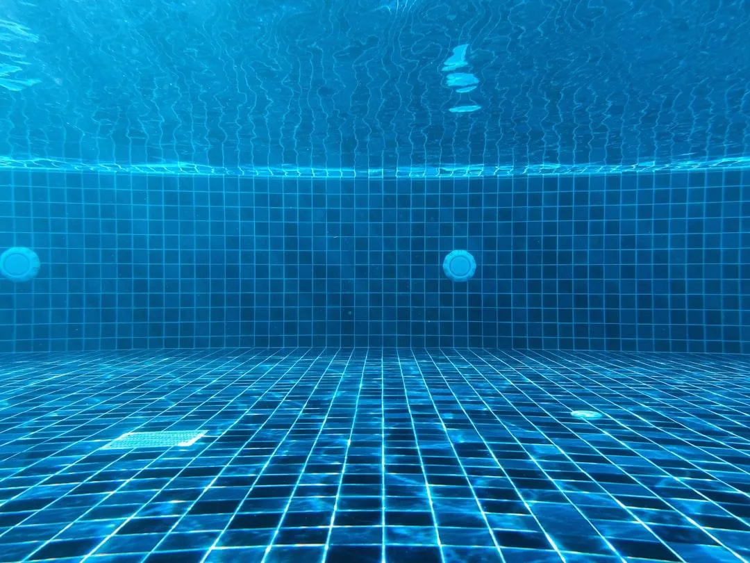 a pool with clear blue water and bubbles