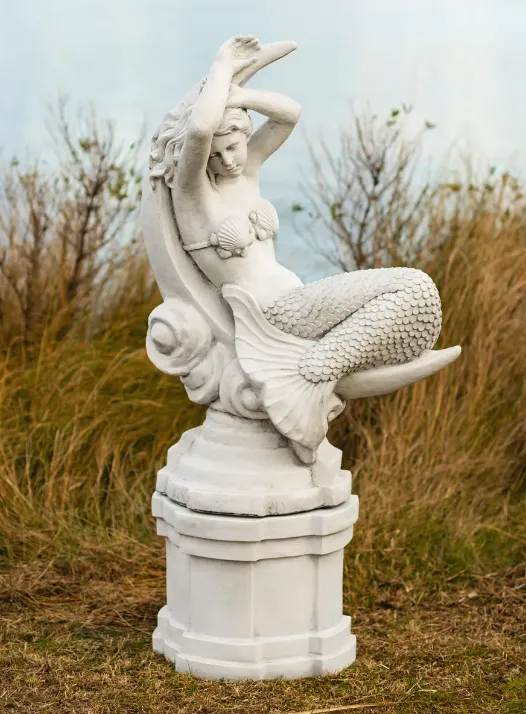 Cast stone architectural element standing strong in a coastal garden setting