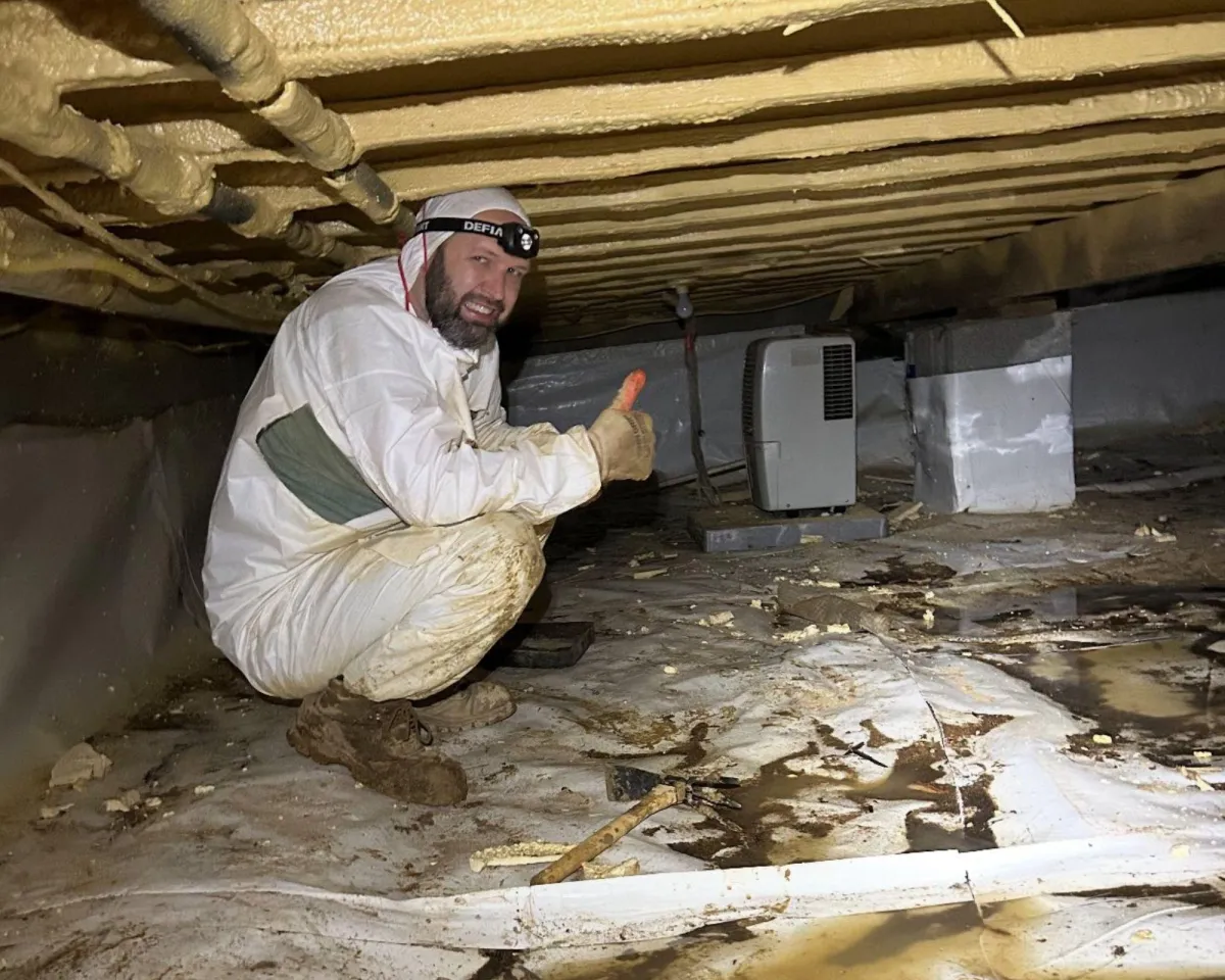 Crawl Space Fixers Technician performing inspection in Arkansas home crawl space
