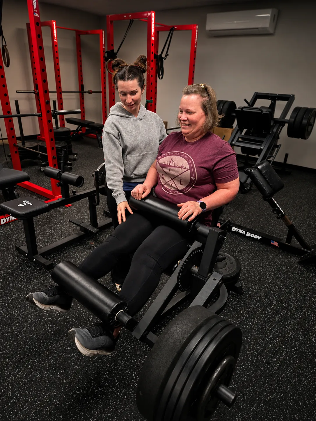 Personal trainer coaching client through leg extension exercise at 4Balance Fitness private gym