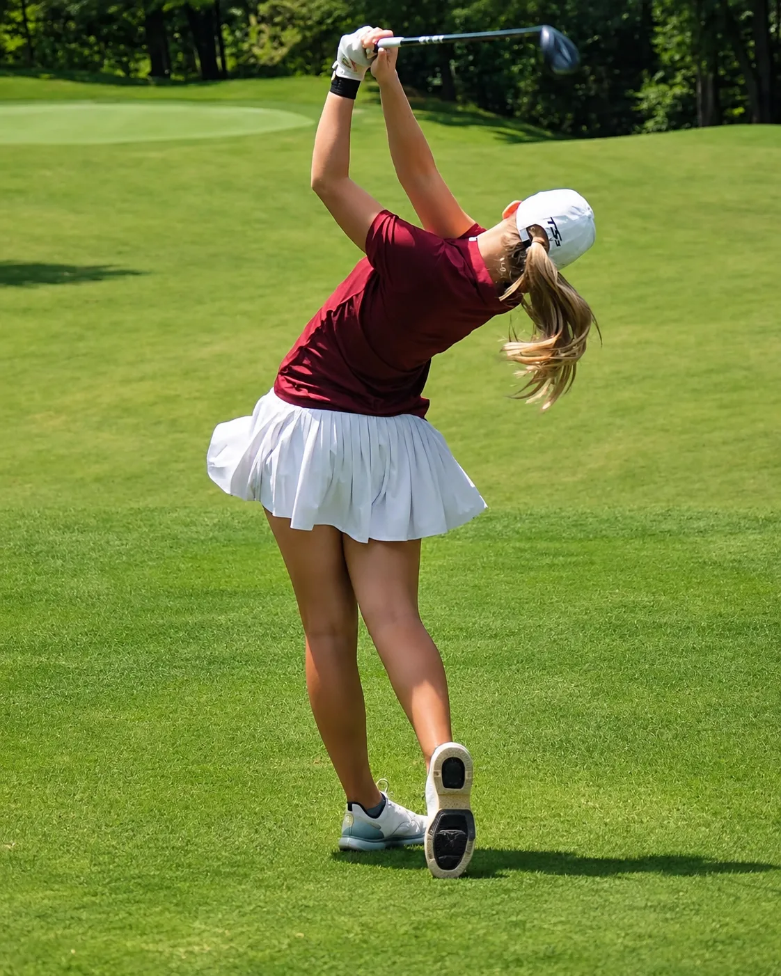 Golfer finishing a powerful swing on the course — 4Balance Forge online golf training