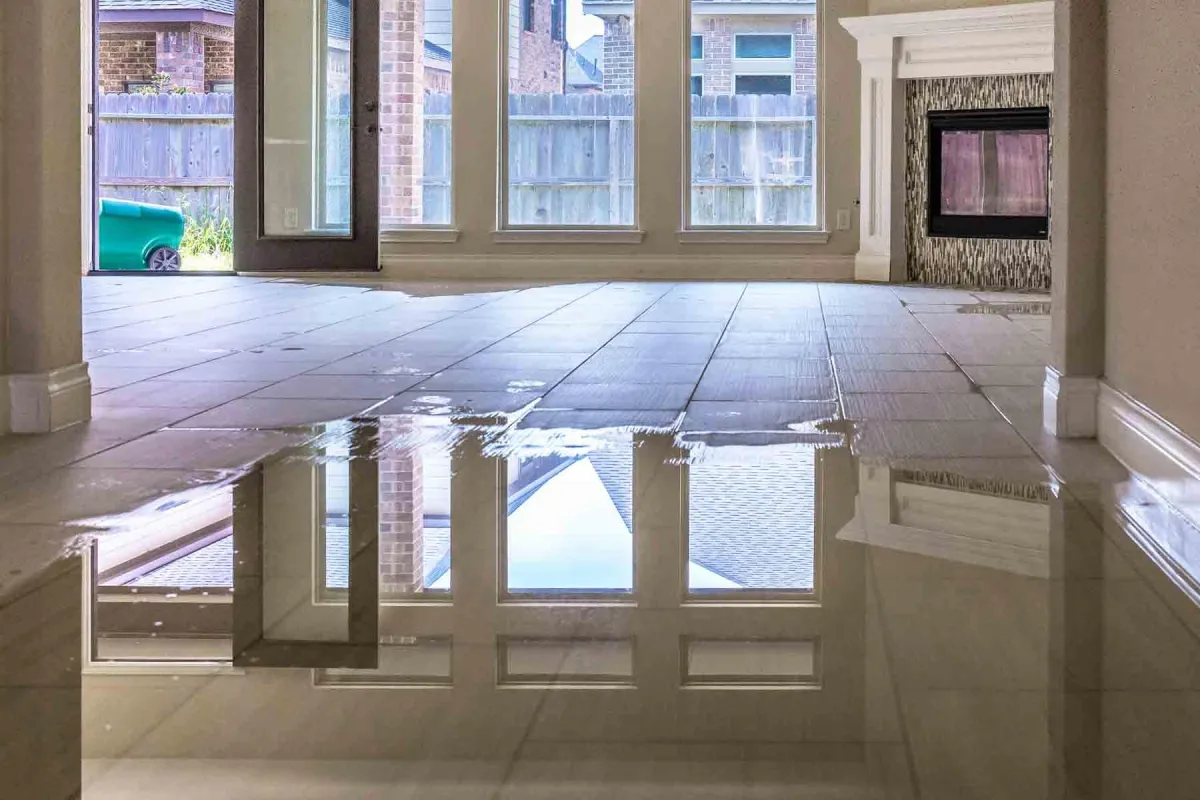 Interior of a flooded house with standing water on the floor after water damage.