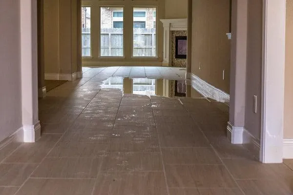 Standing water on the main floor of a house, illustrating the severity of water damage and the urgent need for professional restoration services from VHrestoration.