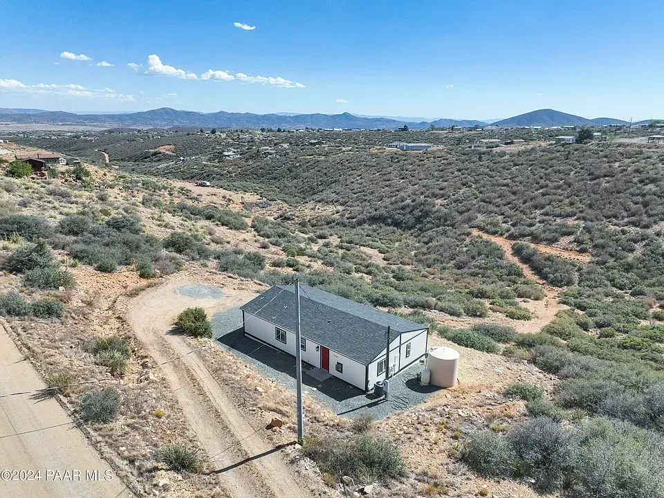 Aerial view of 9285 E Wolf Rd, Dewey, AZ 86327 — showcasing spacious property layout, surrounding landscape, and rural Arizona setting.