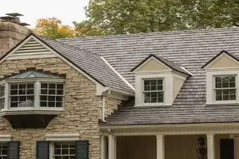 Stone colonial home with premium slate-look roofing materials installed by Eden Prairie Roofing