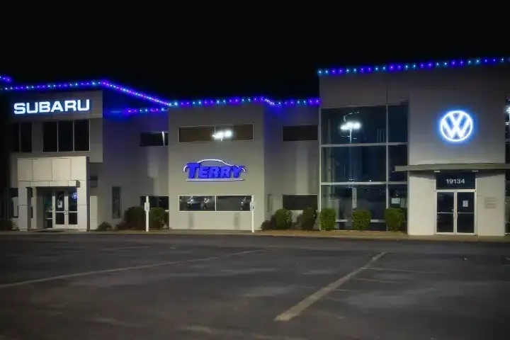 Temporary commercial Christmas light installation on a business building with removable LED roofline lighting and festive seasonal décor.