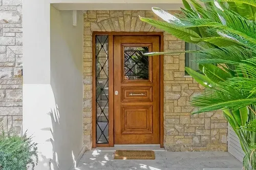 Custom wood entry door with decorative glass panel installed by Pure Windows in Cincinnati, combining durability, curb appeal, and exceptional craftsmanship.