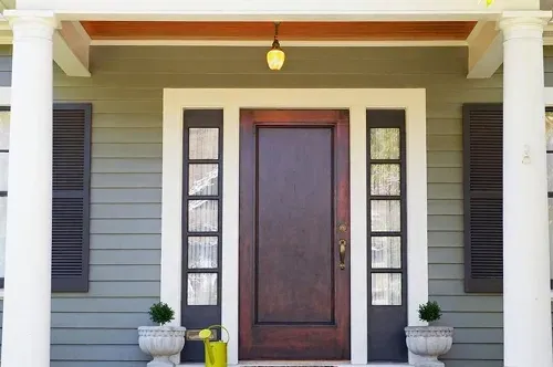 Front entry door replacement on Cincinnati home featuring classic wooden door with decorative glass panels, expertly installed by Pure Windows for style and security